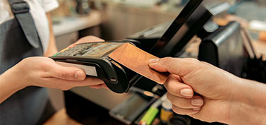 photo of debit card at point of sale - links to business debit card page