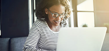 photo of woman on laptop - links to treasury management services page