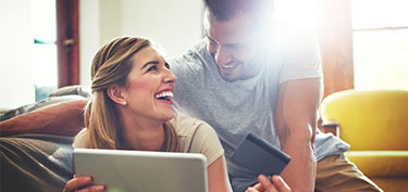 photo of couple shopping online - links to personal banking debit card page