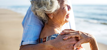 photo of elderly couple on beach - links to personal savings page