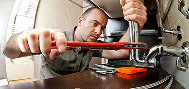 photo of plumber - links to personal loans page